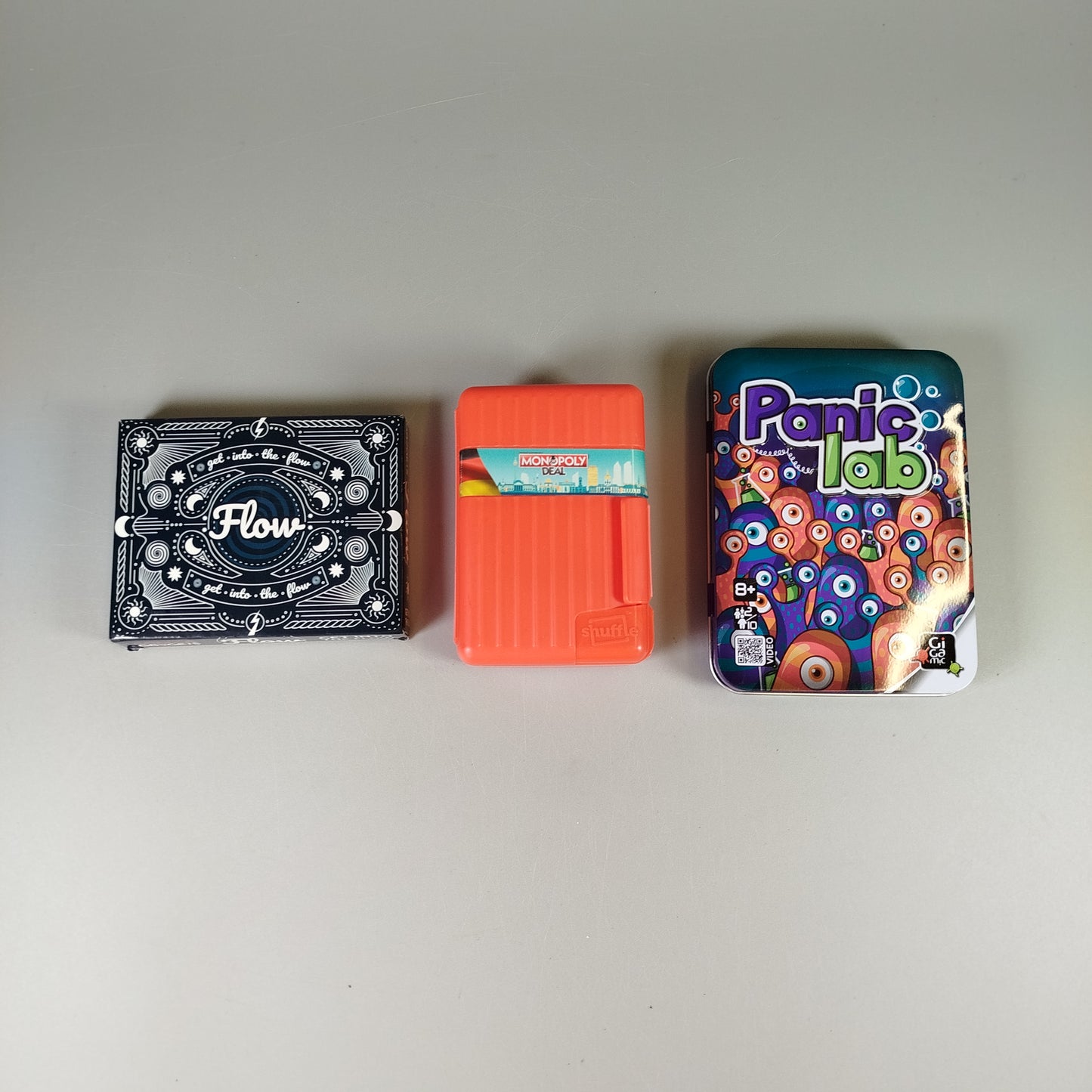 Brettspiel-Set – Flow, Monopoly Deal Shuffle Deutschland, Panic Lab